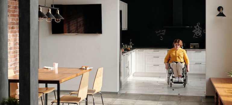 a woman in wheelchair in a kitchen
