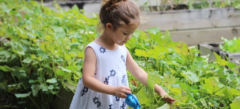 A little girl playing in the garden during the first week in your new Kuna residence