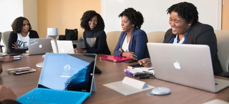Happy people in their office talking about creating a comfortable home office in your Eagle ID home