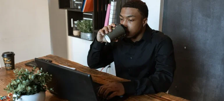 A man researching on his laptop about creating a comfortable home office in your Eagle ID home
