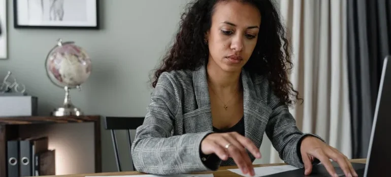 a woman typing on laptop