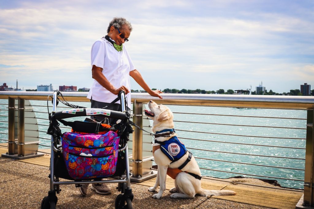 a woman with her guide dog after the process of moving for individuals with special needs