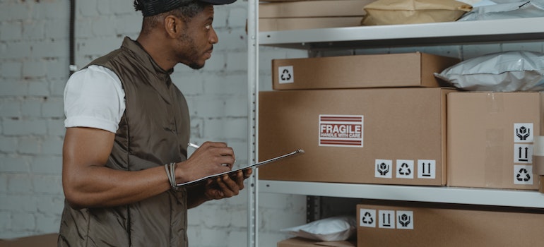 A person checking inventory before they choose the right business storage option