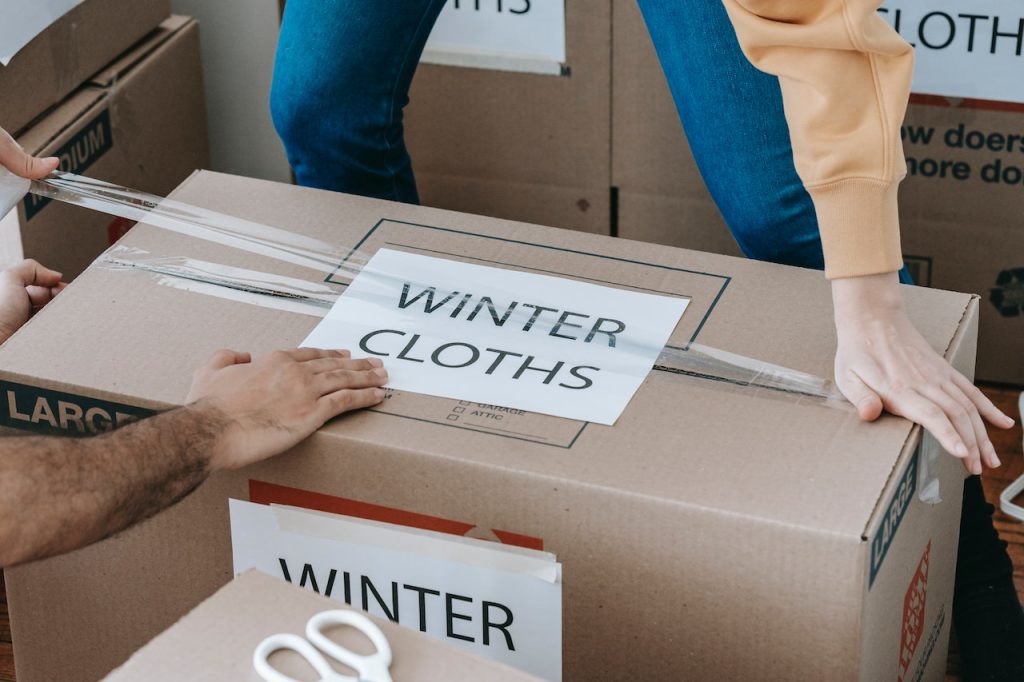 a couple packing winter clothes for keeping your seasonal items organized and safe