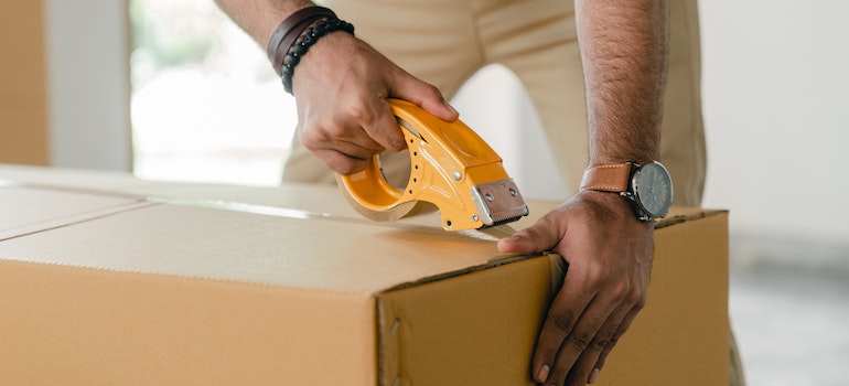 Man taping a box