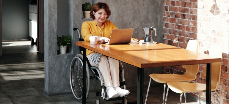 a Woman with with special needs is Using a Laptop