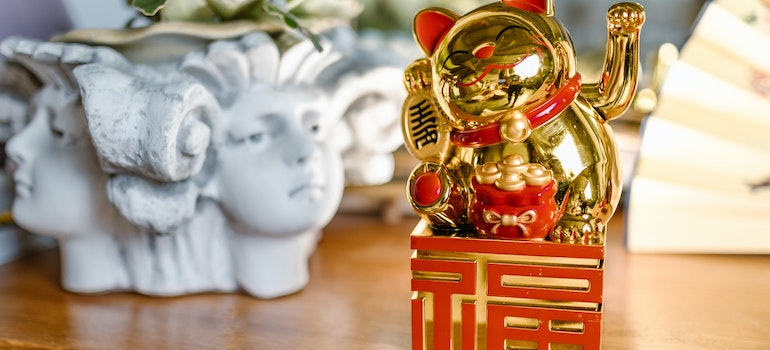 Golden Lucky Cat over a Wooden Table