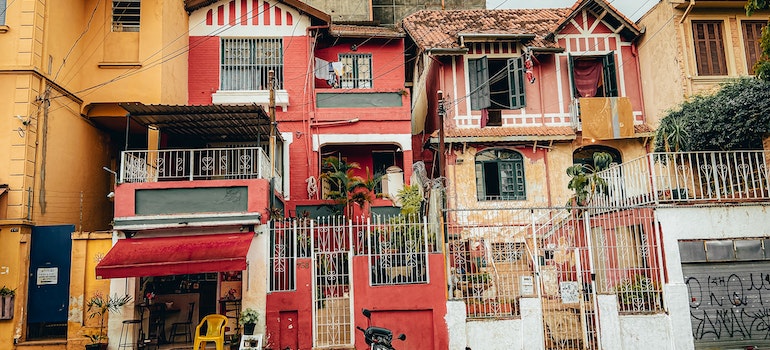 Facades of weathered colorful buildings in old town representing moving traditions and rituals around the world