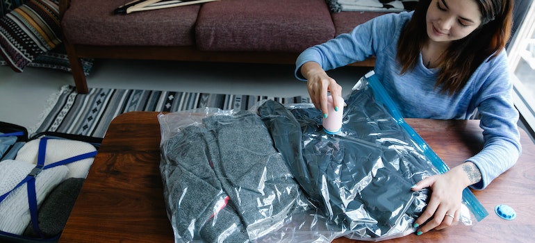 Woman packing clothes in a vacuum bag