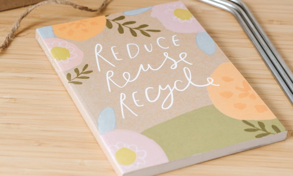 A notebook with 3Rs on a cover promotes reusing and recycling packing materials
