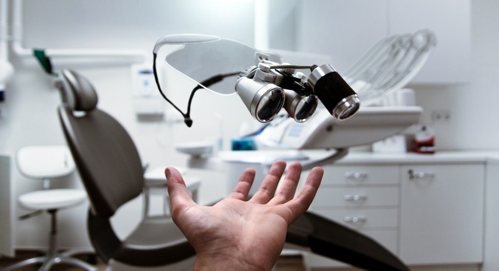 A person showing dentist equipment as a result timely equipment shipments for medical start-ups