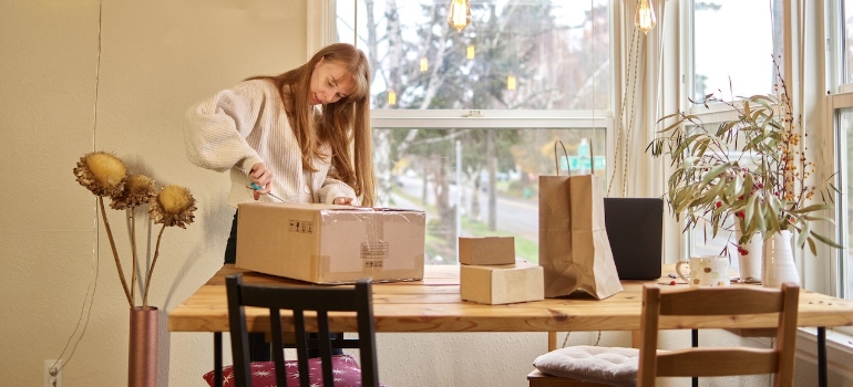 A woman unpacking boxes in her kitchen
