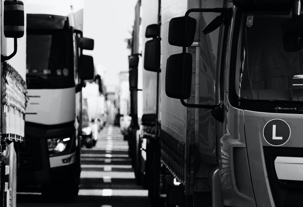 A grayscale photo of a large fleet of trucks signifying importance of fleet management
