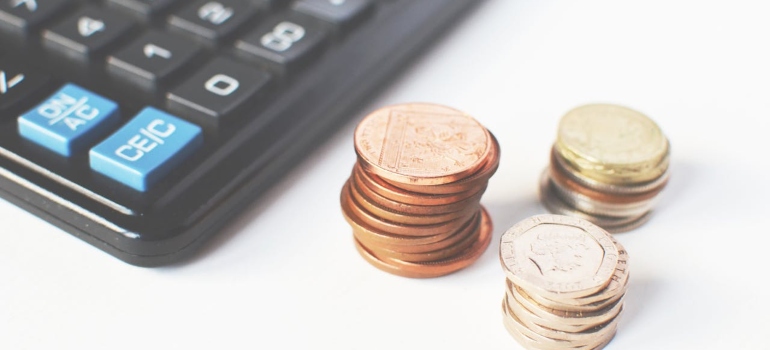 Gold-colored Coins Near Calculator