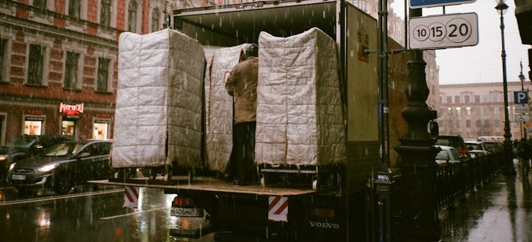 A man loading a truck during rain and spring relocation