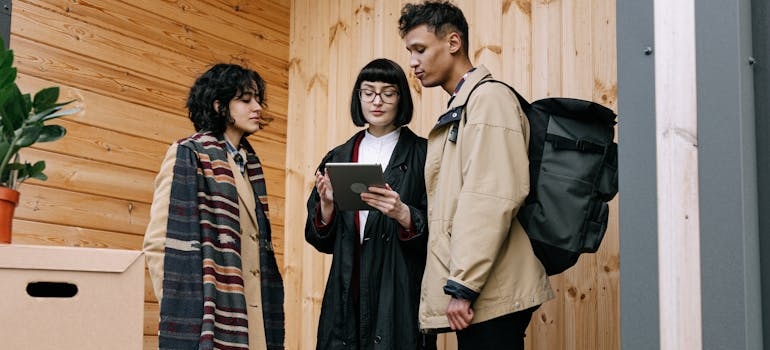 a couple signing a lease with an agent and asking things to discuss before moving in together