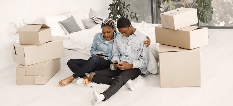 A Young Couple Using their Smartphones to call movers McCall ID