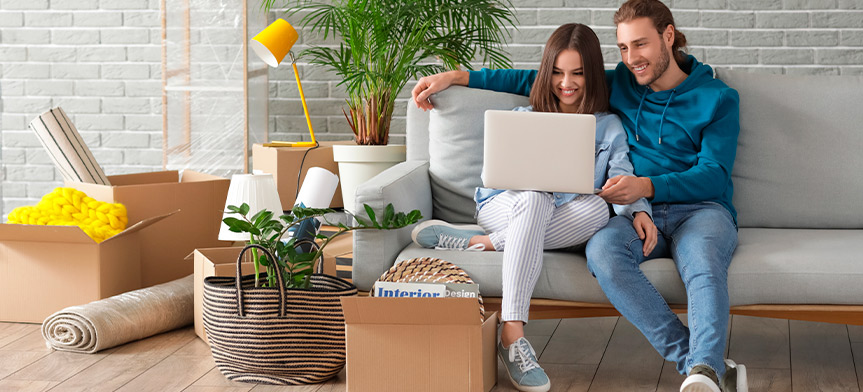 couple checking laptop and doing moving