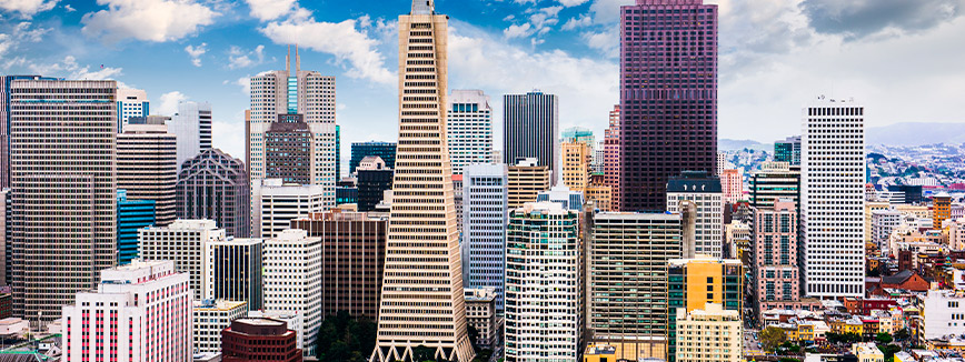 A bustling city skyline featuring numerous tall buildings, symbolizing urban life and relocation opportunities. Moving Guide: Idaho to California Relocation
