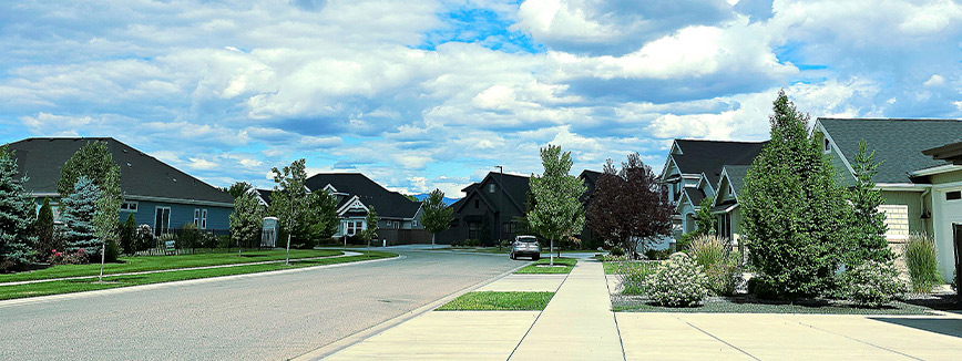 A residential street in Eagle, ID, showcasing houses and a stop sign, part of a neighborhood guide.