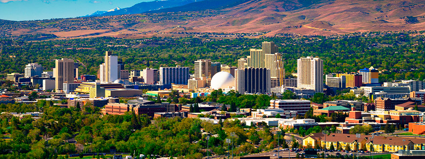 Nevada city skyline with mountains in the background, illustrating the scenic beauty of moving from Idaho to Nevada.