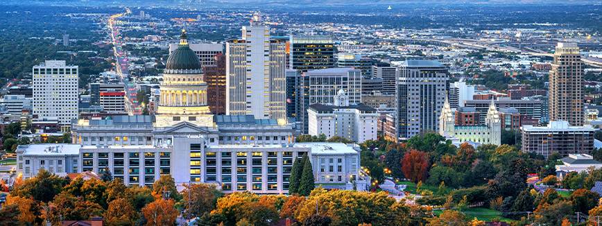 Utah: A bustling cityscape with numerous skyscrapers and greenery, highlighting the contrast between urban and natural elements.