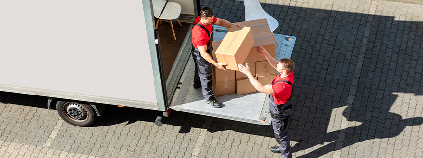 Movers downloading boxes from moving truck