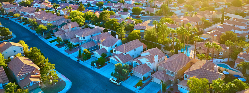 Aerial perspective of a suburban neighborhood, highlighting houses and roads, linked to winter-proofing tips for basements.