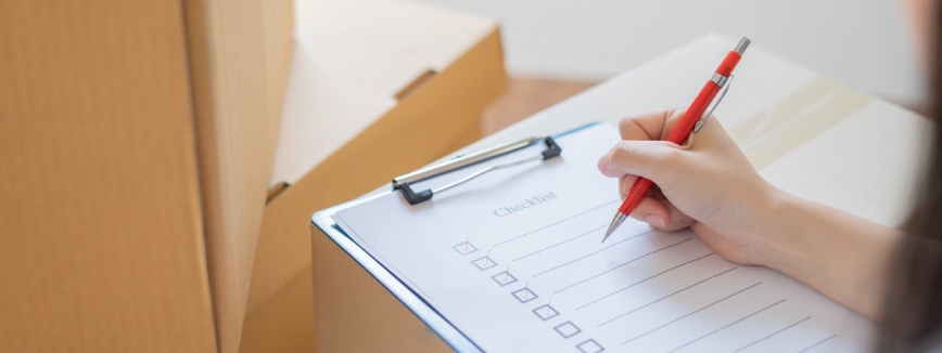 Asian woman checking and packing the carton box prepare to move to new house relocation shipping or check goods package before delivery to customer from online shopping by checklist